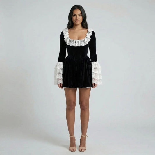 Black velvet mini dress with lace neckline and statement lace cuffs — front view of model.