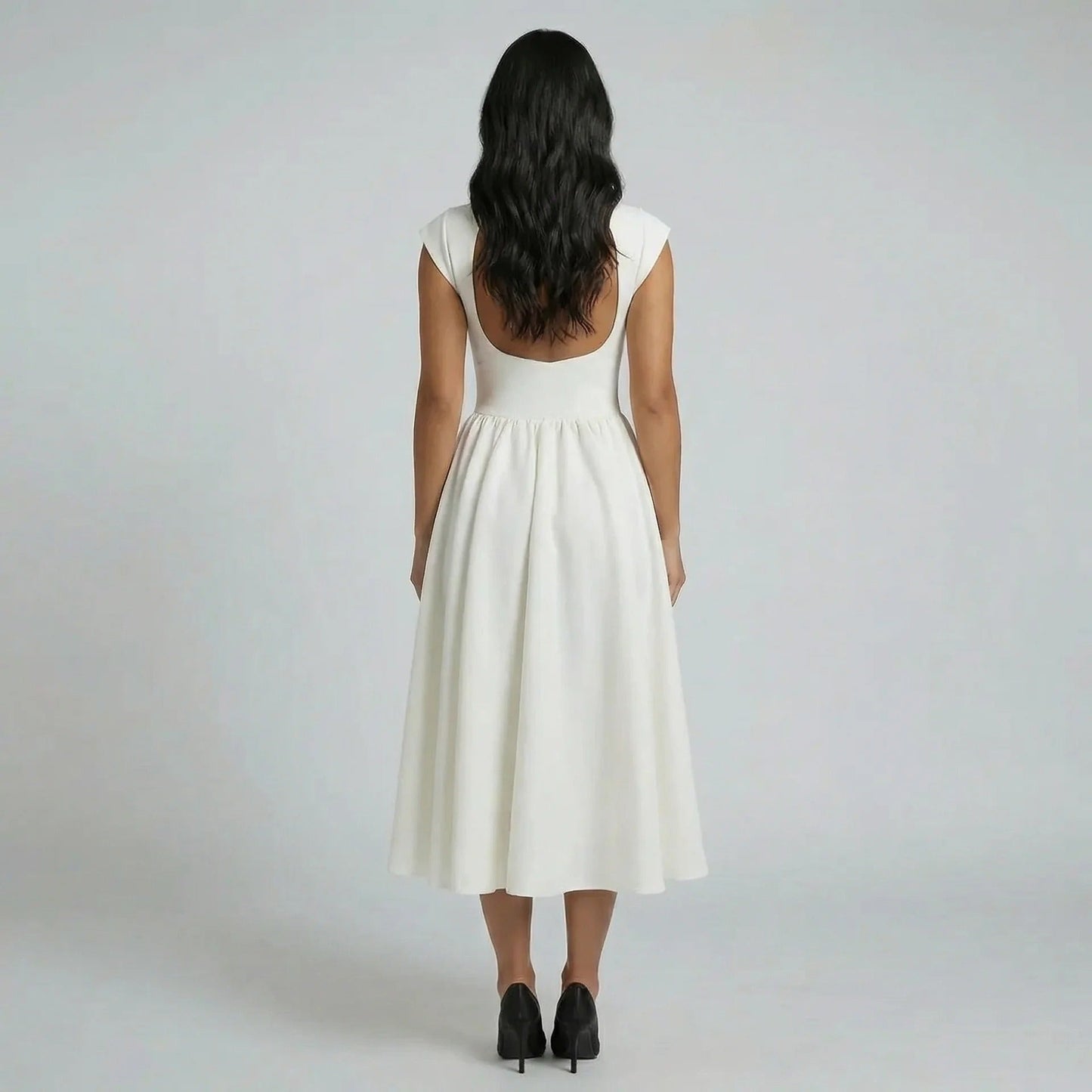 Ivory pleated fit-and-flare midi dress — back view featuring open-back detail and flattering fit.