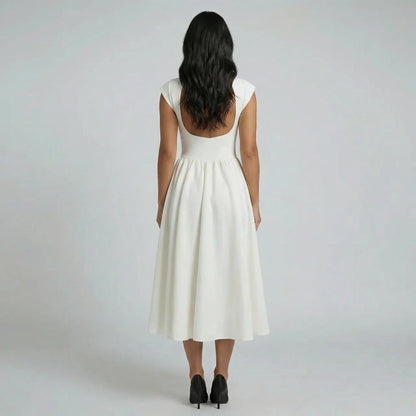 Ivory pleated fit-and-flare midi dress — back view featuring open-back detail and flattering fit.