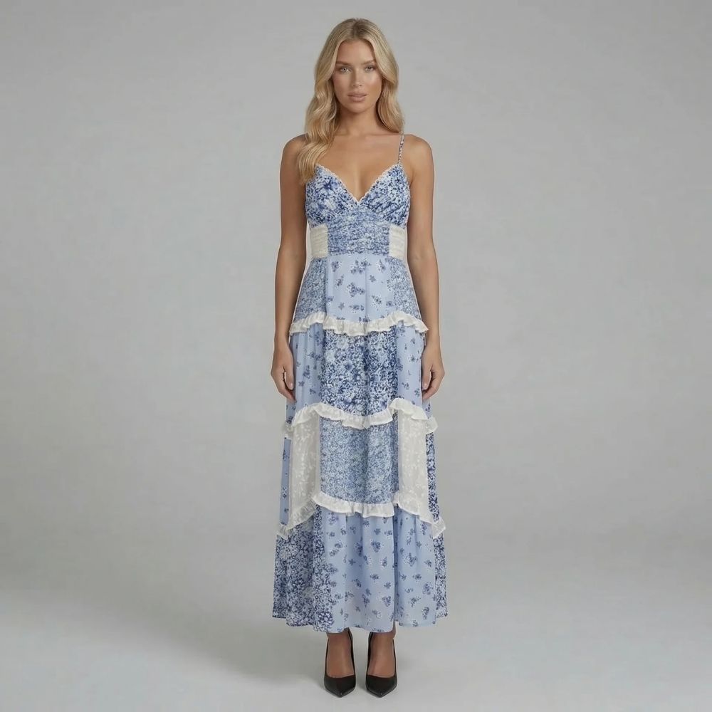 Blue floral tiered maxi dress with delicate ruffles — front view showcasing feminine silhouette and V-neckline