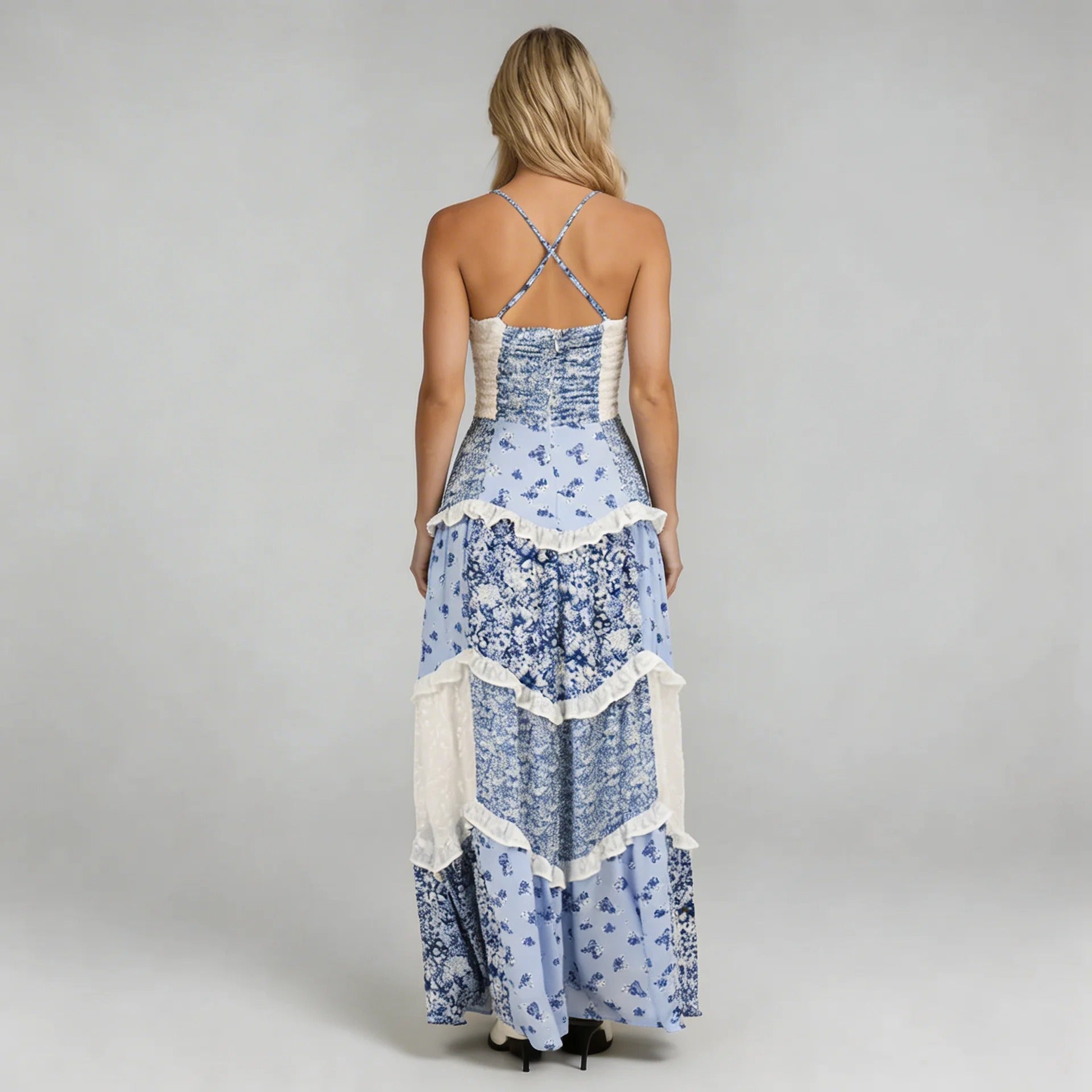 Blue floral tiered maxi dress with cross-back adjustable straps — back view focusing on flowy tiers