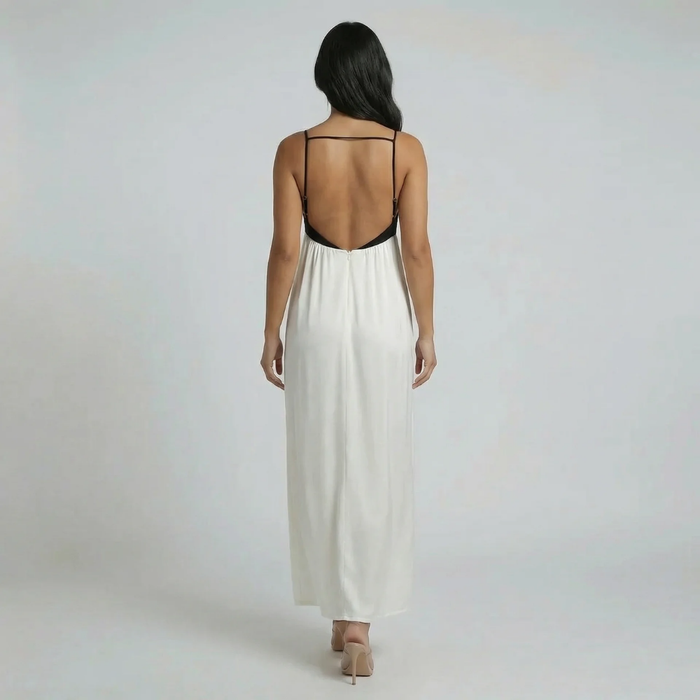 Cream and black colorblock maxi dress — back view displaying low open back design and flowing silhouette.