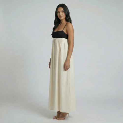 Cream and black colorblock maxi dress with spaghetti straps — front view highlighting fit-and-flare style.
