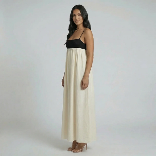 Cream and black colorblock maxi dress with spaghetti straps — front view highlighting fit-and-flare style.