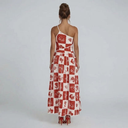 Red and white floral patchwork maxi dress with scalloped trim — back view highlighting asymmetric neckline.