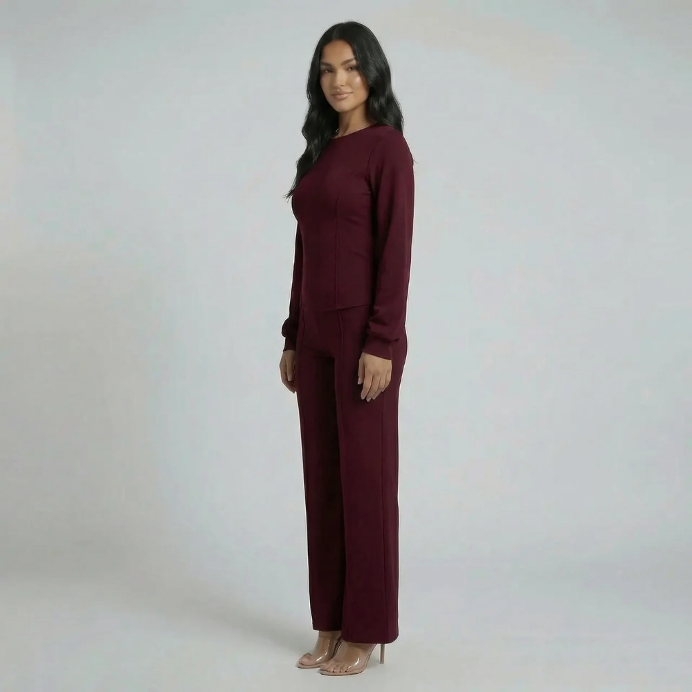 Burgundy tailored set — angled side view highlighting structured waist and refined silhouette.