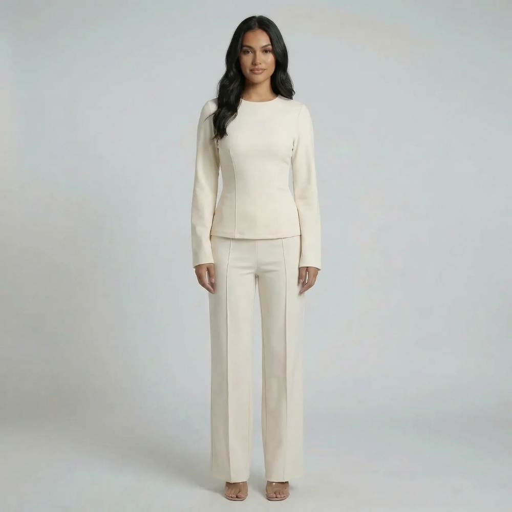 White tailored two-piece set — front view showing crew neck structured top with long sleeves and wide-leg pants.
