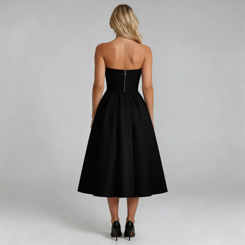 Black strapless pleated midi dress — back view showing zip closure and elegant silhouette