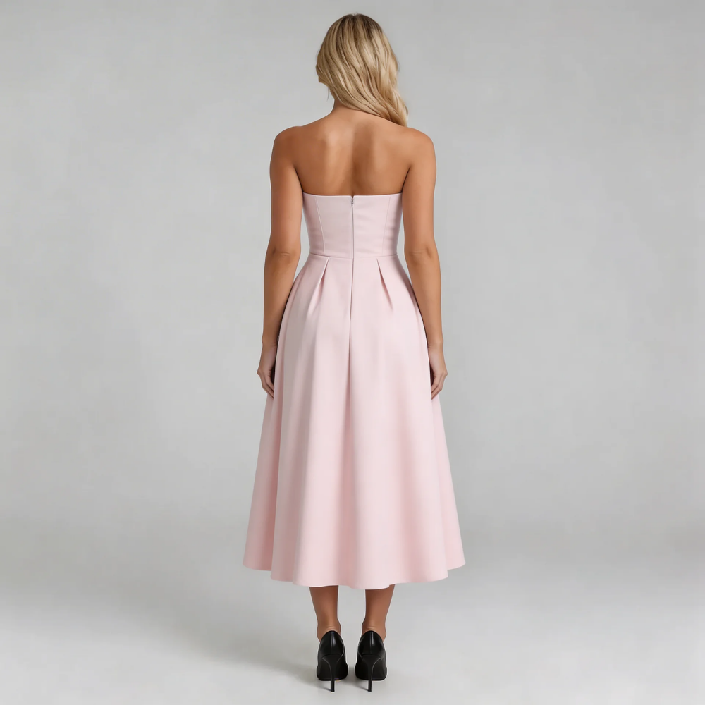 Pink strapless pleated midi dress — back view highlighting pleats and secure zip closure