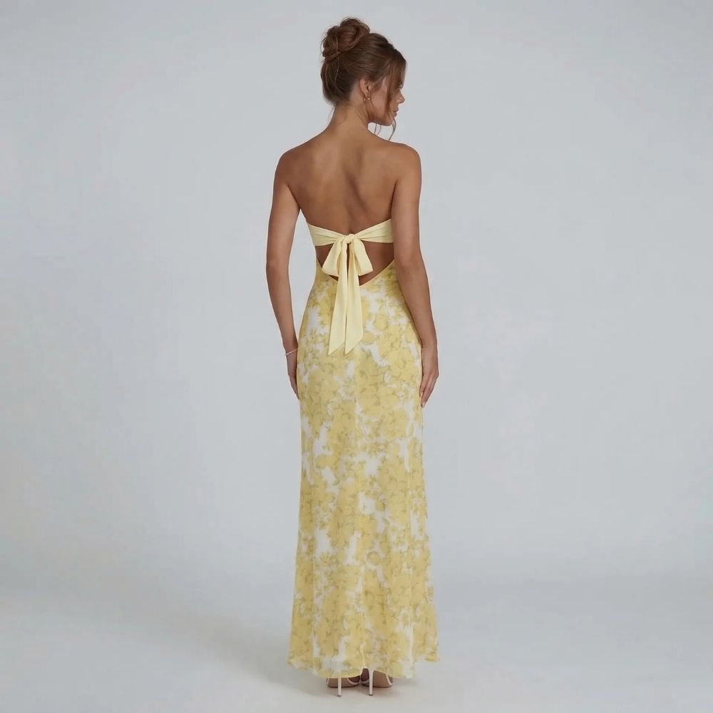 Yellow strapless cutout maxi dress — back view showing bow detail