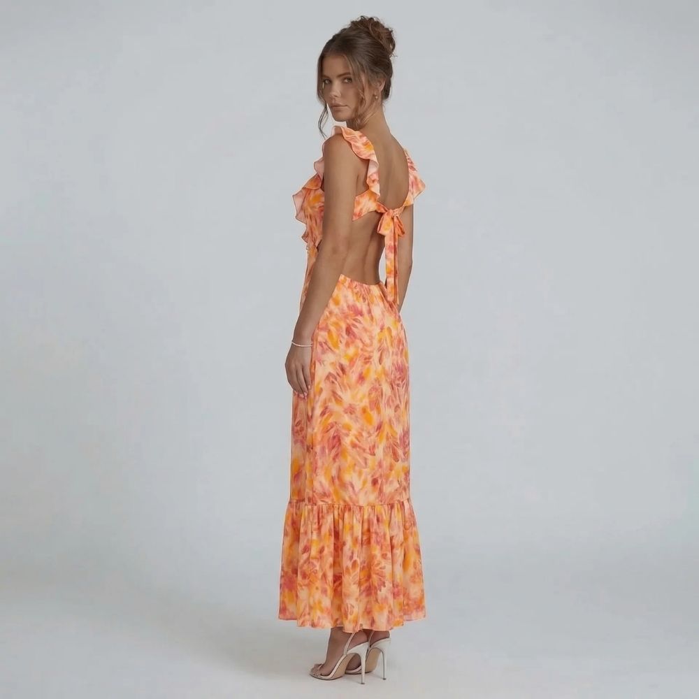 Orange watercolor ruffle maxi dress — back view highlighting open-back tie detail and flowing silhouette